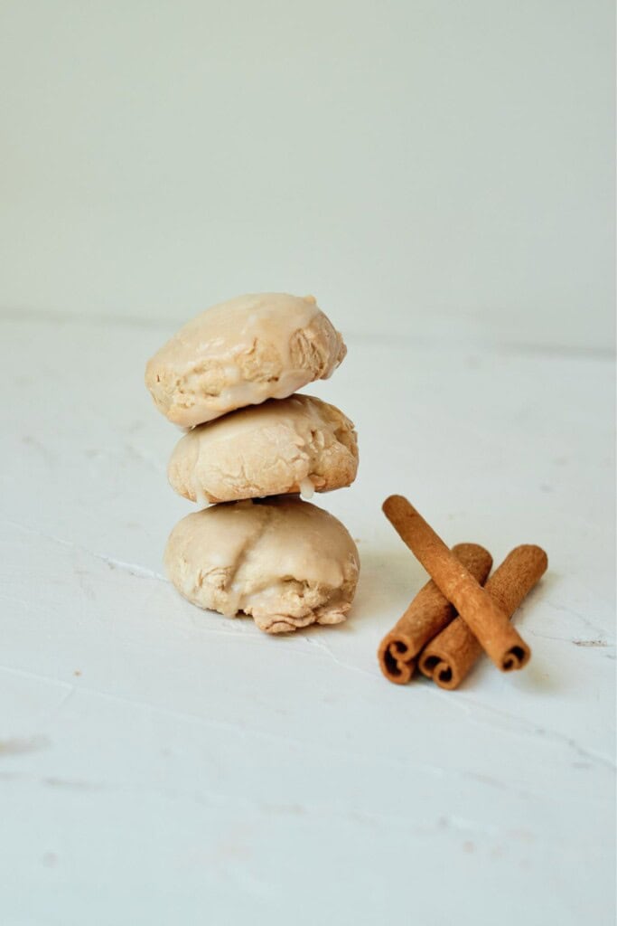 Cinnamon sticks next to a stack of the butter pecan cake mix cookies.