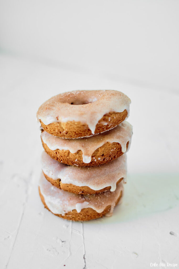 A towering stack of cinnamon donuts ready to eat or share. 