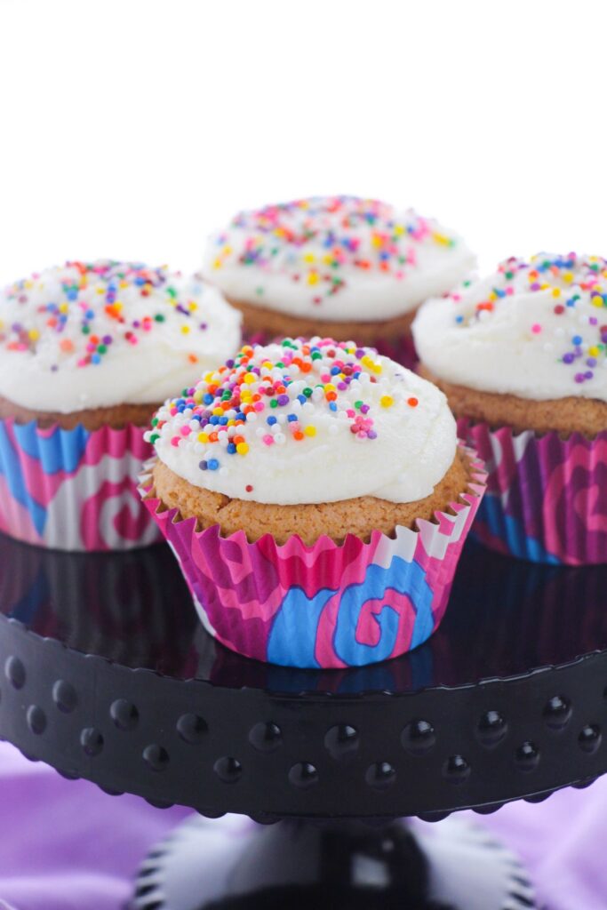 a closeup of 4 cake mix cupcakes on a cake stand