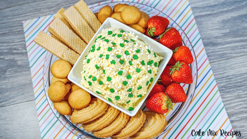 Finished dip on a serving tray with cookies and fruit for dunking. 