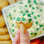 A hand scooping out some on a cookie.