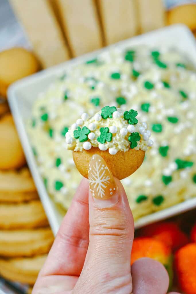 A hand scooping out some on a cookie.