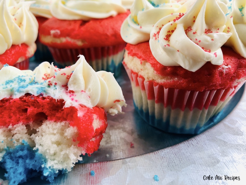 A close up look at one of the cupcakes bitten so you can see the red white and blue layers inside! 