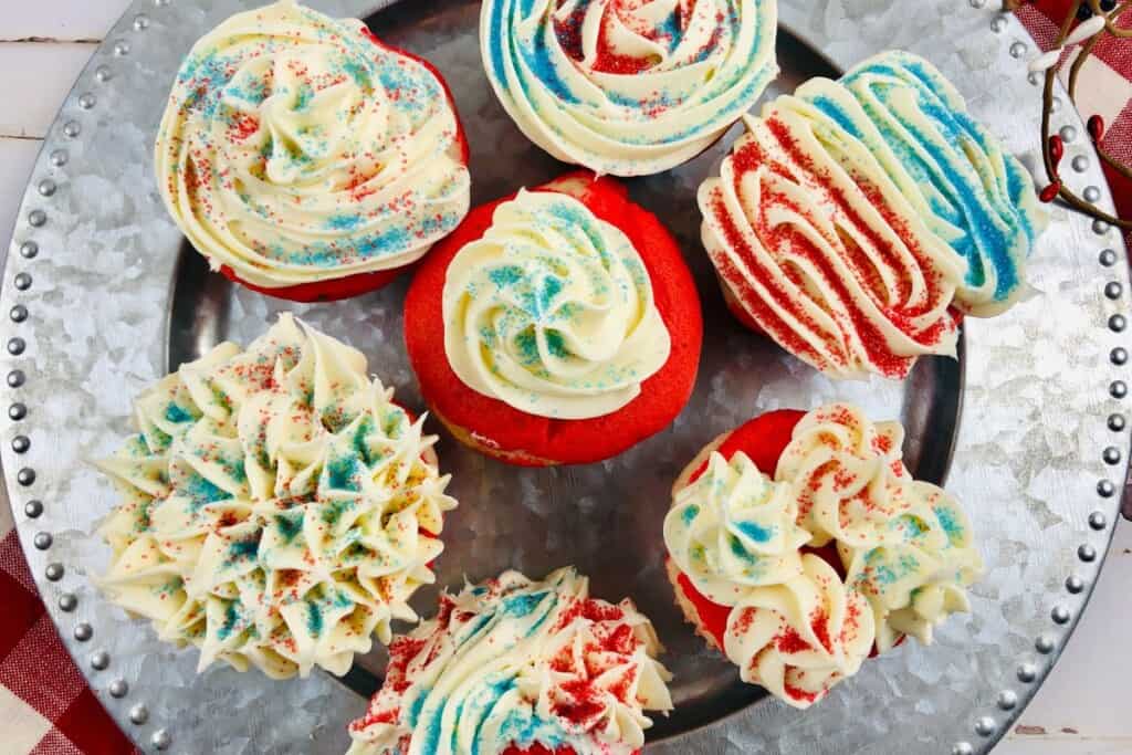 A platter of festive red white and blue cupcakes.
