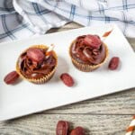Two root beer cupcakes on a plate.