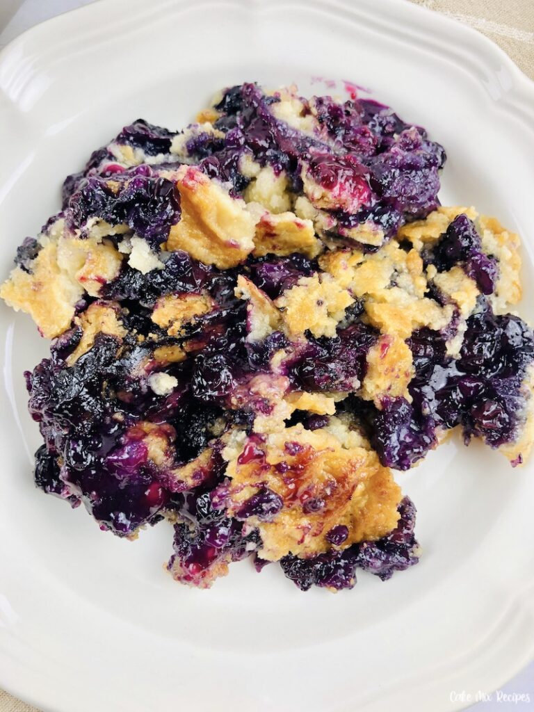 A vertical shot of the finished bowl full of blueberry dump cake. 