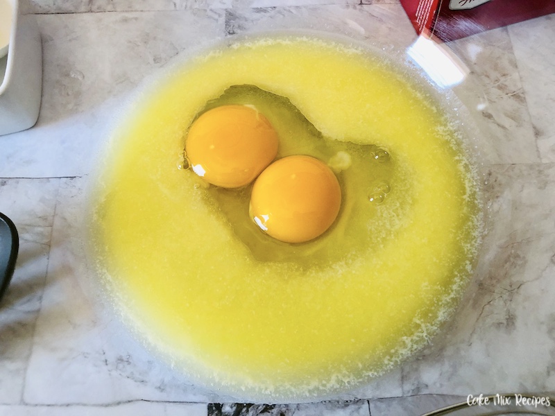 ingredients being prepared eggs and wet ingredients in a mixing bowl