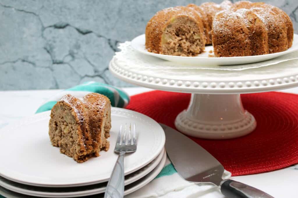 A slice of cake with a platter in the background.