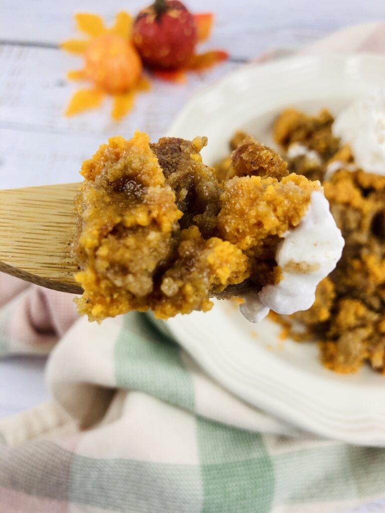 A spoonful of the finished pumpkin spice dump cake ready to eat.