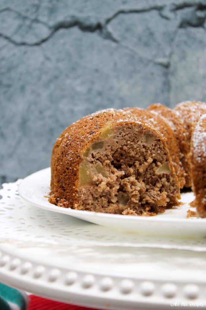 a close up view of the finished recipe for apple bundt cake sliced and ready to share. 
