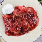 featured image showing the finished recipe for strawberry dump cake ready to eat.