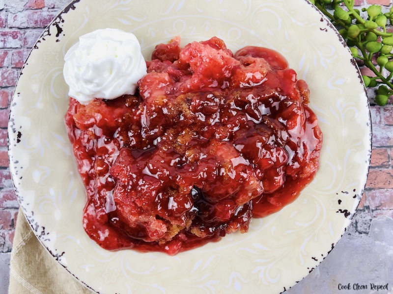 featured image showing the finished recipe for strawberry dump cake ready to eat.