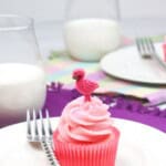 Strawberry and cream cupcakes with a side of milk.