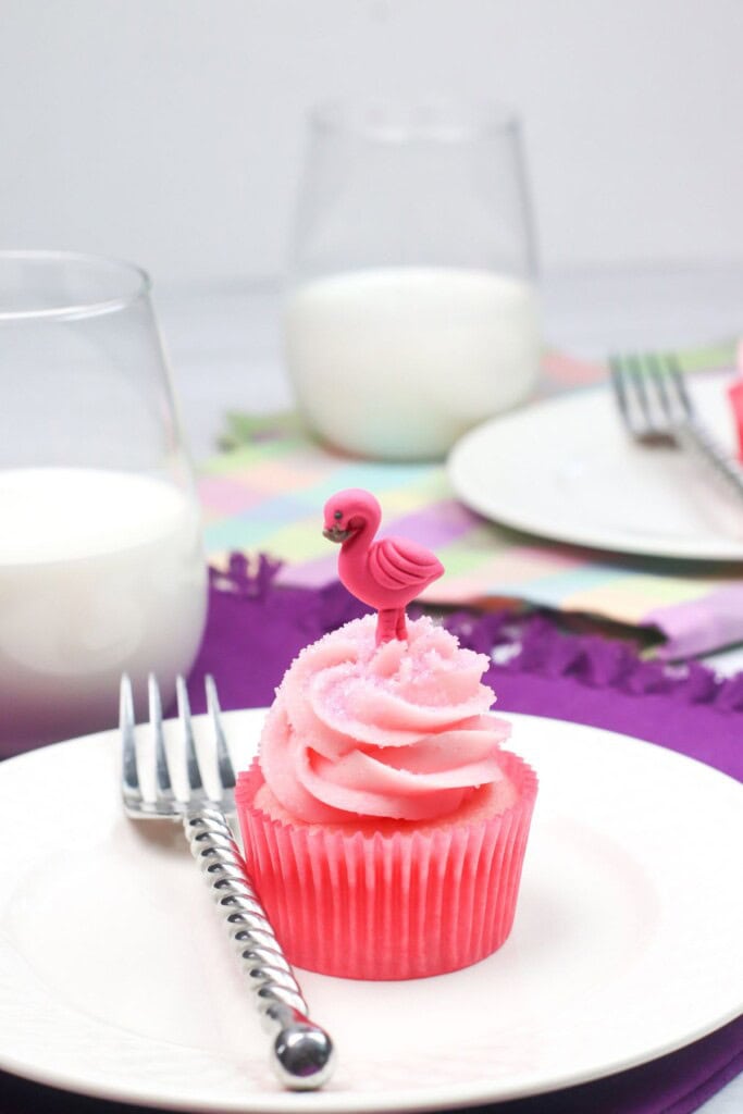 Strawberry and cream cupcakes with a side of milk.