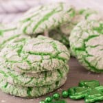 A stack of green vanilla crinkle cookies with green beads.