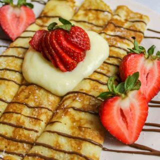 pancake mix crepes topped with vanilla custard, chocolate syrup, and fresh strawberries
