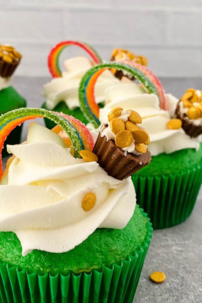 A close up on the rainbow st patricks day cupcake.