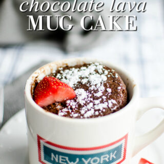 chocolate lava mug cake with powder sugar and strawberries