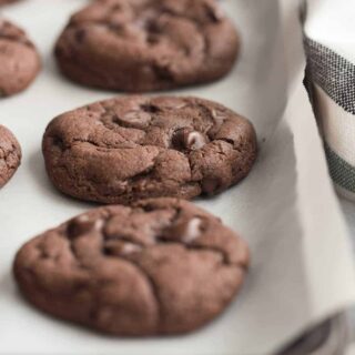 double chocolate cake mix cookies on a pan with chocolate chips