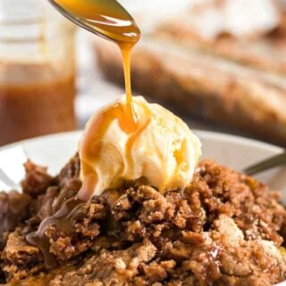 apple dump cake topped with vanilla ice cream and caramel drizzle