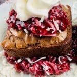 A brownie with raspberry sauce and whipped cream.