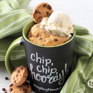chocolate chip mug cake topped with a chocolate chip cookie and vanilla ice cream