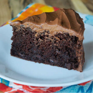 slow cooker chocolate cake topped with chocolate frosting