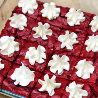 red velvet cake mix brownies topped with frosting and served in a baking pan