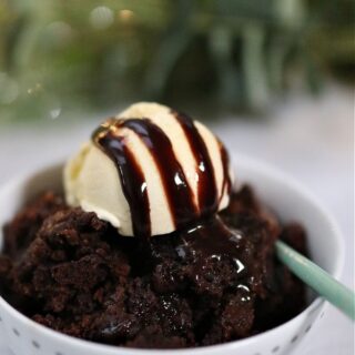 slow cooker chocolate cake with vanilla ice cream and chocolate drizzle