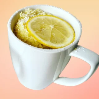 lemon mug cake topped with a fresh lemon slice