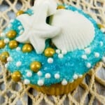 Beach cupcakes on a wooden board.