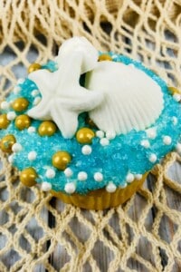 Beach cupcakes on a wooden board.