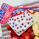 A Tray of patriotic cake mix dip with fruit on the side.
