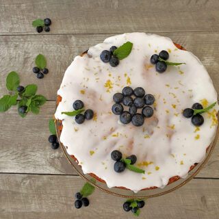 Fresh blueberry cake mix cake with white icing and blueberries on top