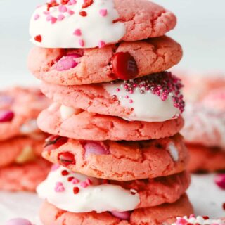 strawberry cake mix cookies stacked on top of one another with various toppings like sprinkles and m&ms