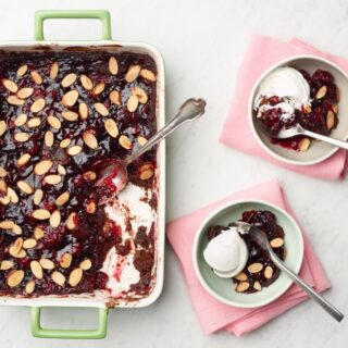 a casserole dish and two small bowls of chocolate cherry dump cake