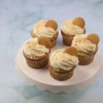 A cake tray with banana pudding cupcakes on it.