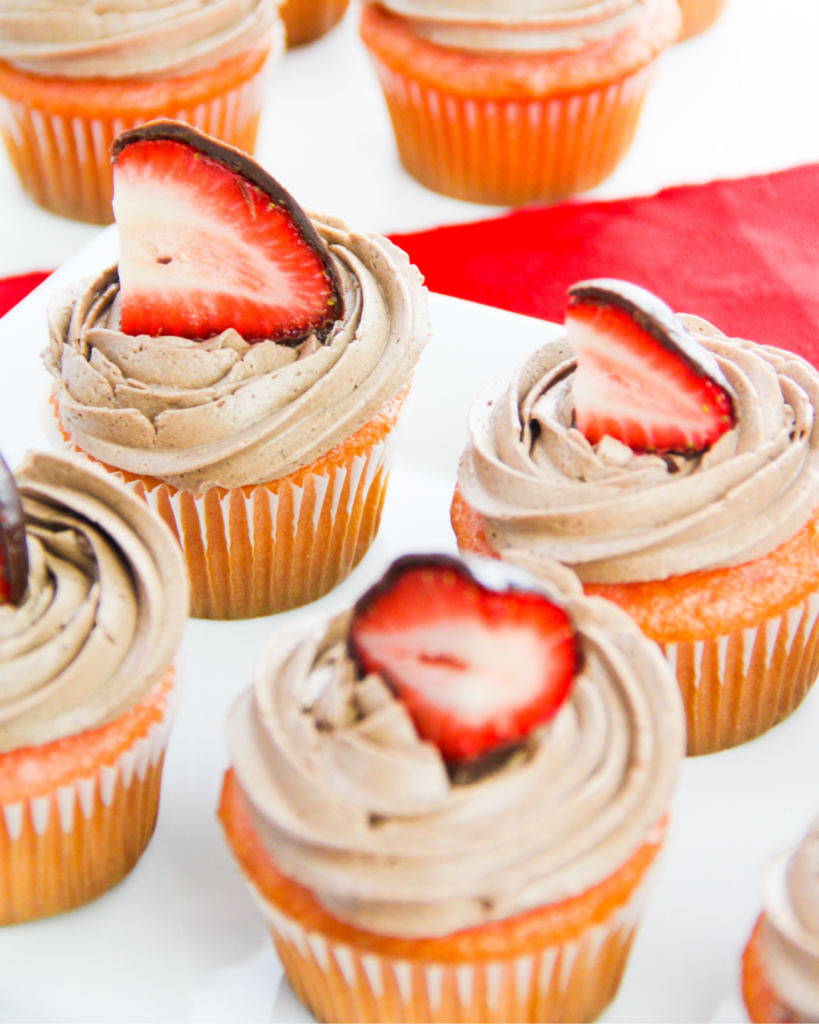 a closeup of strawberry chocolate cupcakes on a white plate 