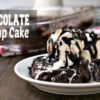plate of chocolate dump cake toped with cool vanilla ice cream and drizzled with chocolate fudge
