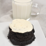 microwave oreo cake on a white plate with a glass of milk in the background