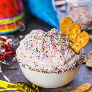 bowl of funfetti dip with crackers in it for dipping