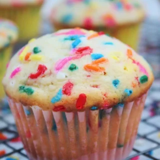 A colorful rainbow funfetti muffin