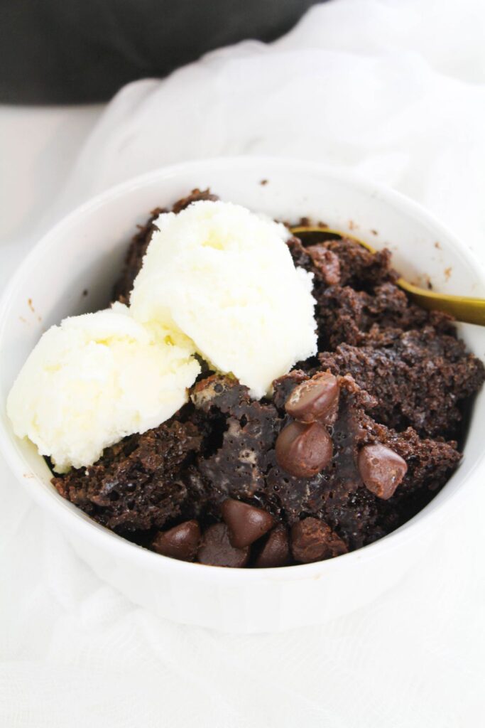 Chocolate Lava Cake in a Crock Pot in a bowl topped with ice cream 