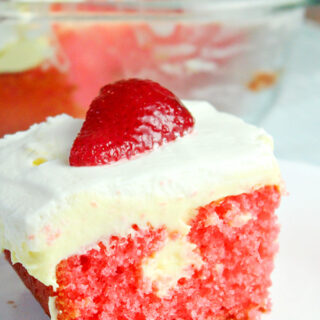 lemon strawberry poke cake with fresh strawberry slice on top