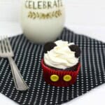 Milk and a delicious treat on a placemat with a fork.