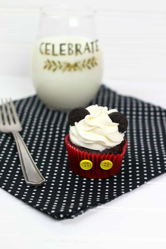 Milk and a delicious treat on a placemat with a fork.