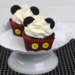 Two mickey cupcakes on a white platter.