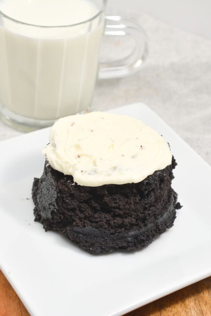 An oreo cupcake on a white square plate.