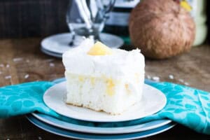 A slice of pina colada cake with a blue napkin.