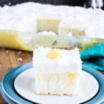A side view of the pina colada cake on a blue plate.